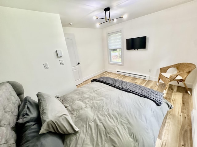 1110 Lehigh Cir, Tobyhanna, PA 18466 - bedroom featuring a baseboard radiator, a chandelier, and wood finished floors