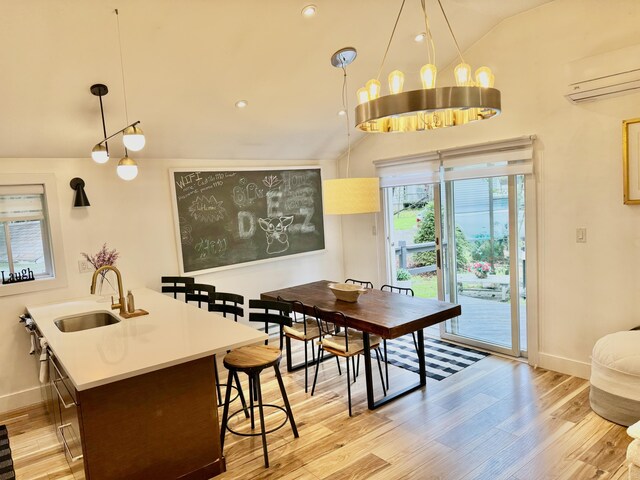 1110 Lehigh Cir, Tobyhanna, PA 18466 - dining area featuring an AC wall unit, lofted ceiling, and light wood-style floors