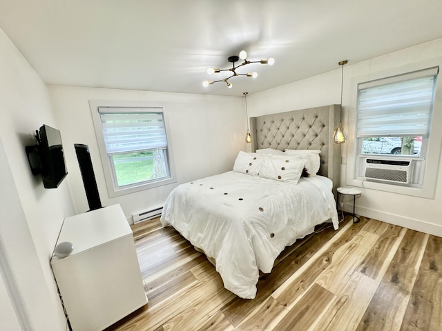 1110 Lehigh Cir, Tobyhanna, PA 18466 - bedroom featuring a baseboard radiator, a chandelier, wood finished floors, and cooling unit