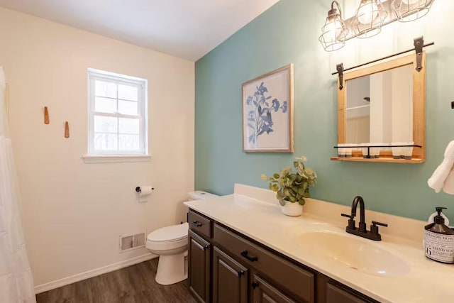 3114 Fairfax Ter, East Stroudsburg, PA 18301 - bathroom with visible vents, baseboards, toilet, vanity, and wood finished floors