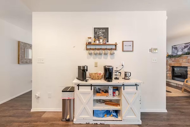 3114 Fairfax Ter, East Stroudsburg, PA 18301 - bar featuring a fireplace, dark wood-type flooring, and baseboards