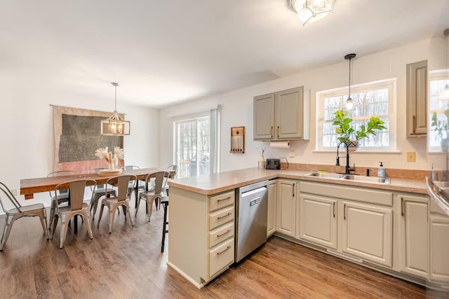 3114 Fairfax Ter, East Stroudsburg, PA 18301 - kitchen with a peninsula, light wood-style flooring, a healthy amount of sunlight, dishwasher, and a sink
