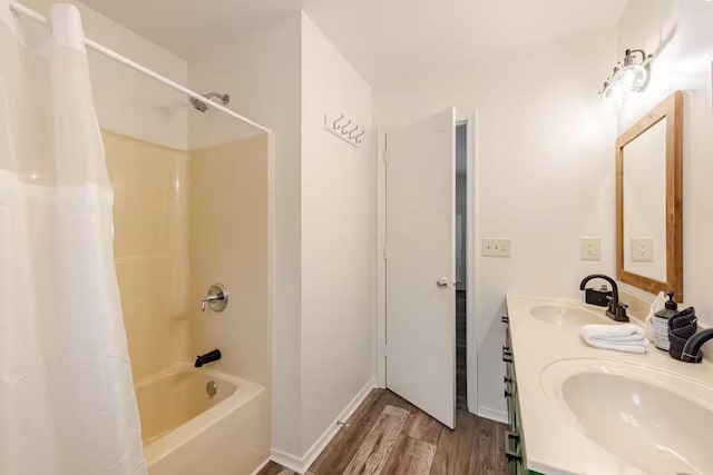 3114 Fairfax Ter, East Stroudsburg, PA 18301 - bathroom featuring wood finished floors, double vanity, a sink, and shower / tub combo with curtain