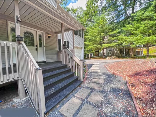 3114 Fairfax Ter, East Stroudsburg, PA 18301 - view of exterior entry featuring a porch and a garage