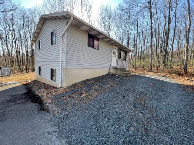 view of side of property with aphalt driveway