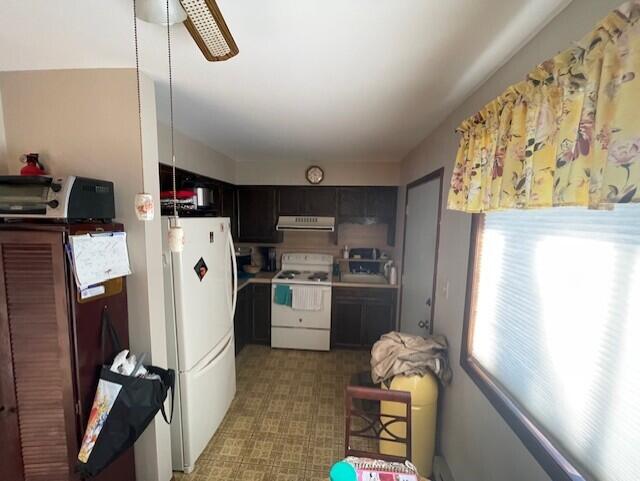 kitchen featuring ceiling fan, light floors, light countertops, range hood, and white appliances