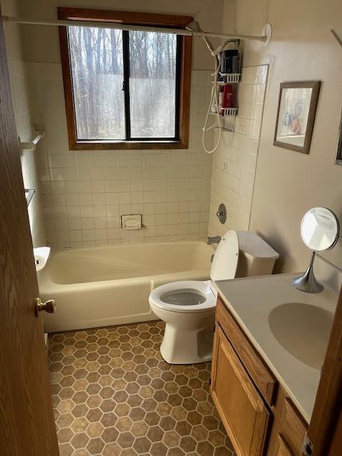 bathroom with vanity, toilet, and tub / shower combination