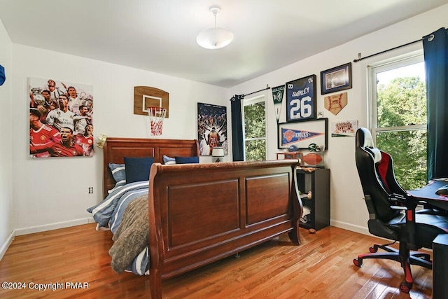 bedroom with baseboards and light wood-style floors