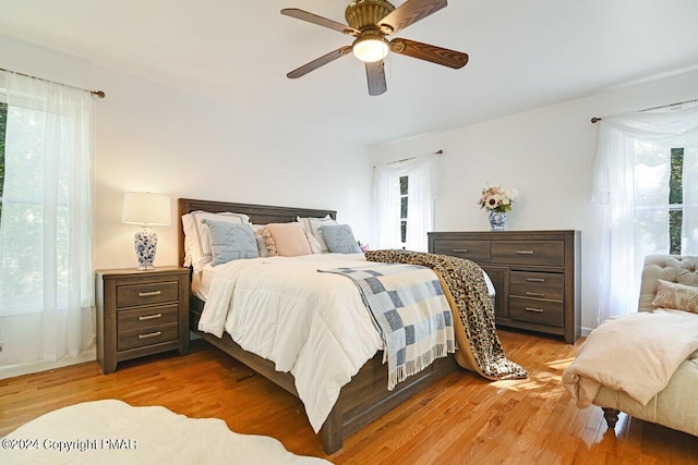 bedroom featuring light wood-style flooring and a ceiling fan