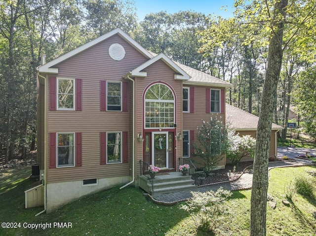 view of front of house with a front lawn and roof with shingles