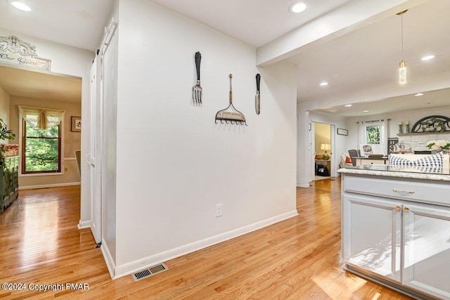 kitchen with recessed lighting, light countertops, visible vents, light wood-type flooring, and baseboards