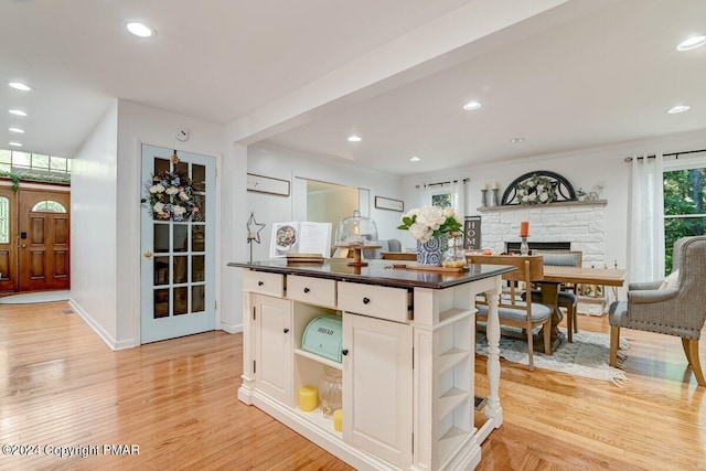 kitchen with dark countertops, recessed lighting, light wood finished floors, and open shelves