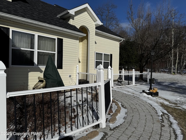 exterior space with roof with shingles