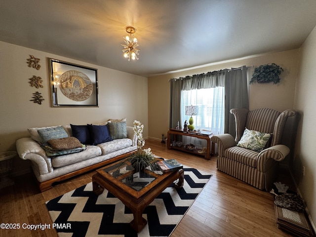 living area with a notable chandelier and wood finished floors