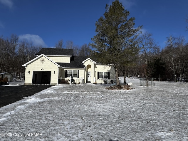 view of front of property with an attached garage and aphalt driveway