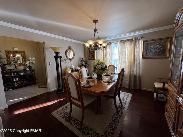 dining space featuring crown molding, baseboards, dark wood finished floors, and a notable chandelier