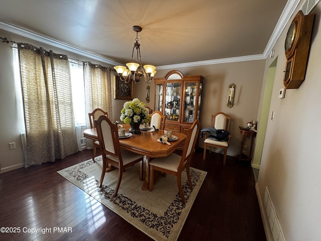 dining area featuring a notable chandelier, visible vents, baseboards, ornamental molding, and dark wood-style floors