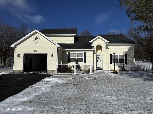 ranch-style home with a garage, driveway, a shingled roof, and covered porch