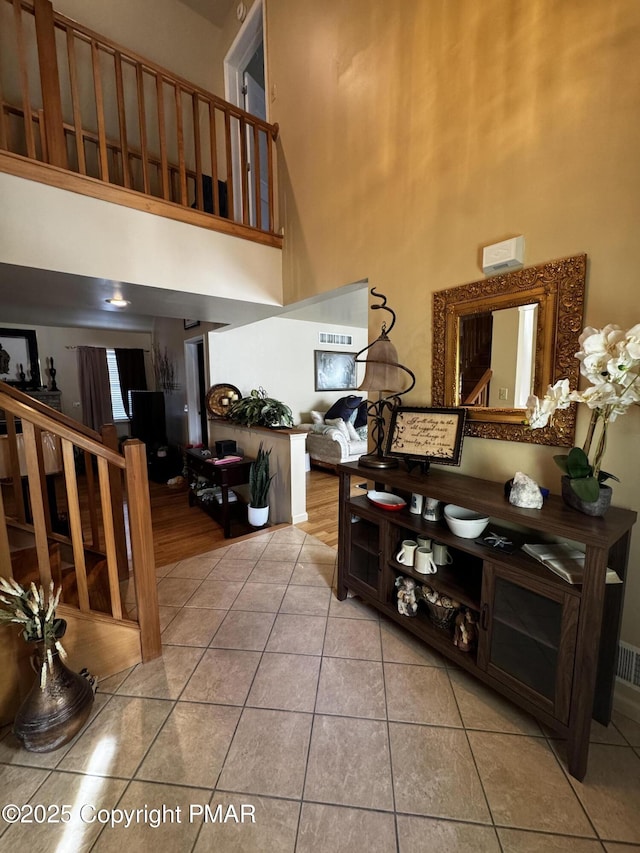 interior space featuring stairway and a high ceiling