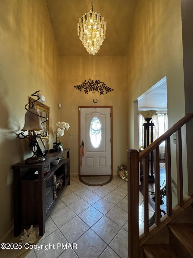 entryway with baseboards, stairway, high vaulted ceiling, a notable chandelier, and light tile patterned flooring