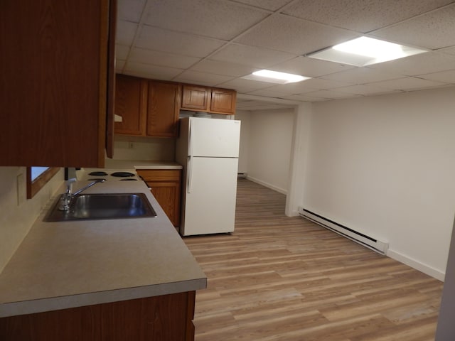 3277 State St, White Haven, PA 18661 - kitchen featuring freestanding refrigerator, a baseboard heating unit, light wood-type flooring, brown cabinets, and a paneled ceiling