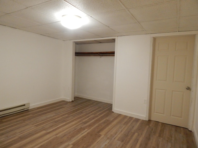 3277 State St, White Haven, PA 18661 - unfurnished bedroom with a drop ceiling, light wood finished floors, a closet, and a baseboard heating unit