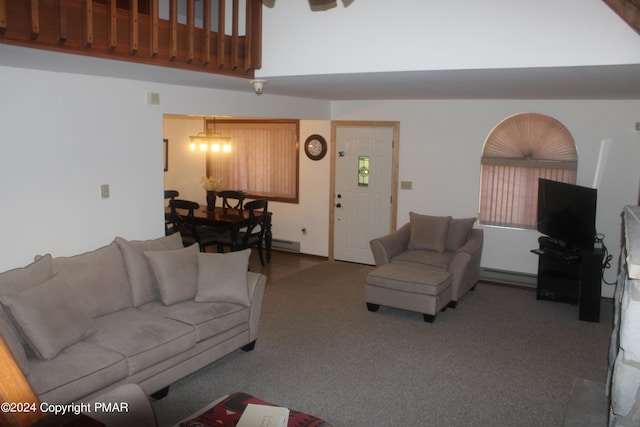 living area featuring carpet and a towering ceiling