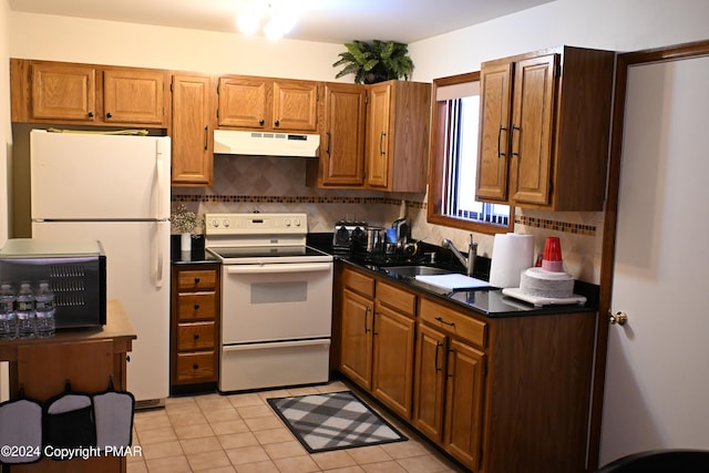 kitchen featuring sink, light tile patterned floors, white appliances, and decorative backsplash