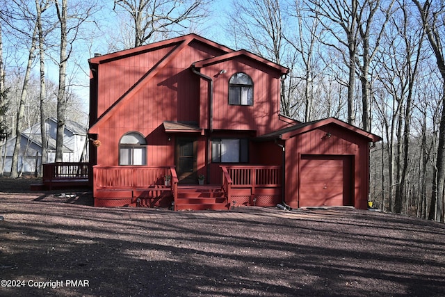 rustic home featuring a garage and a wooden deck