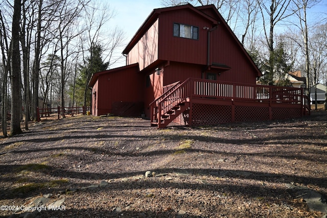 back of property with a wooden deck