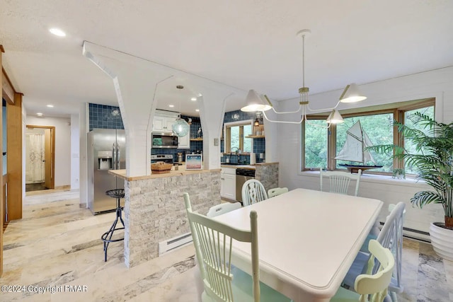 dining area featuring marble finish floor, baseboard heating, and recessed lighting