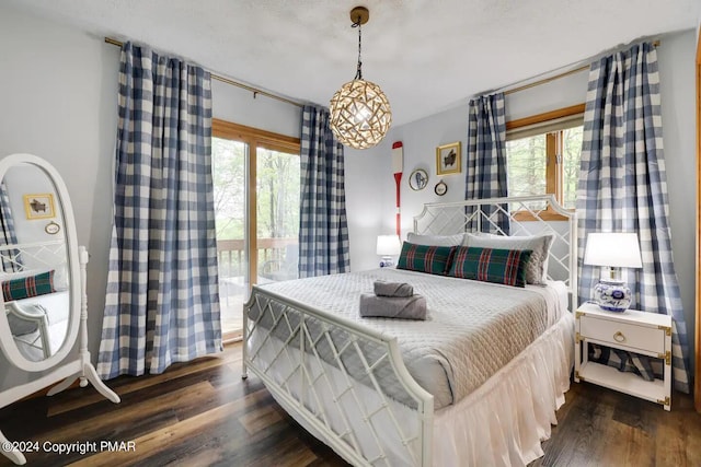 bedroom featuring dark wood-style flooring and access to exterior