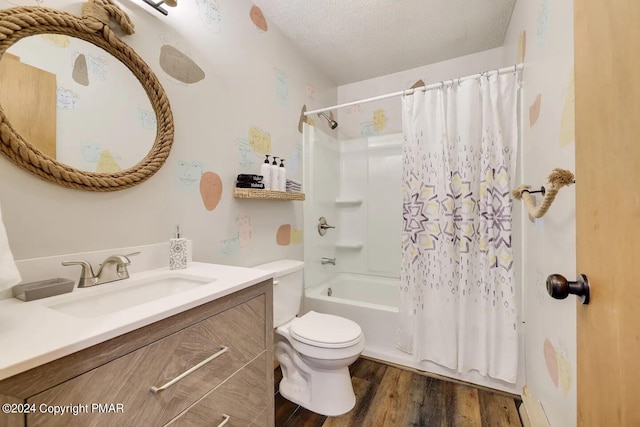 bathroom featuring toilet, wood finished floors, shower / bathtub combination with curtain, a textured ceiling, and vanity