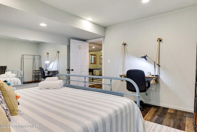 bedroom featuring baseboards, wood finished floors, and recessed lighting