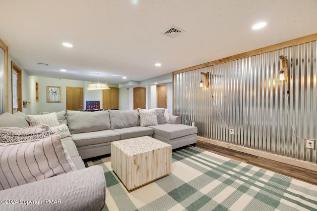 living room with light wood-style flooring, visible vents, and recessed lighting