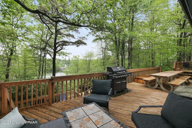 wooden deck with grilling area and outdoor dining area