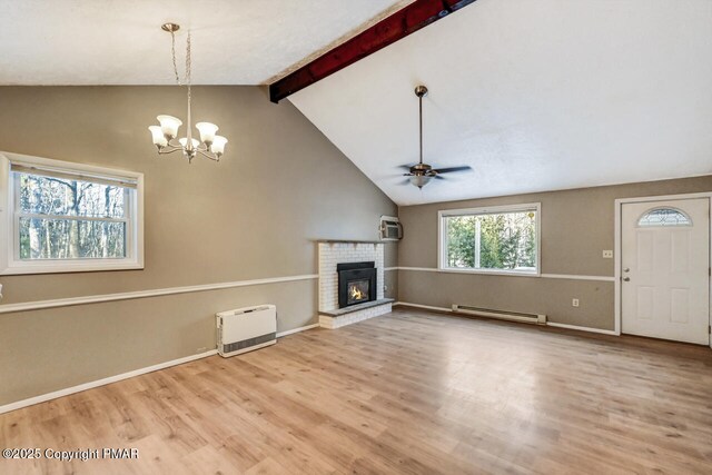 unfurnished living room with heating unit, vaulted ceiling with beams, a brick fireplace, hardwood / wood-style flooring, and a baseboard heating unit