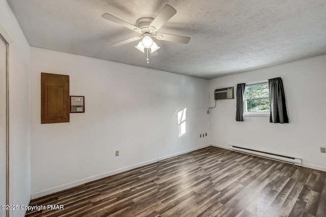 spare room with a baseboard radiator, dark hardwood / wood-style flooring, electric panel, ceiling fan, and a textured ceiling