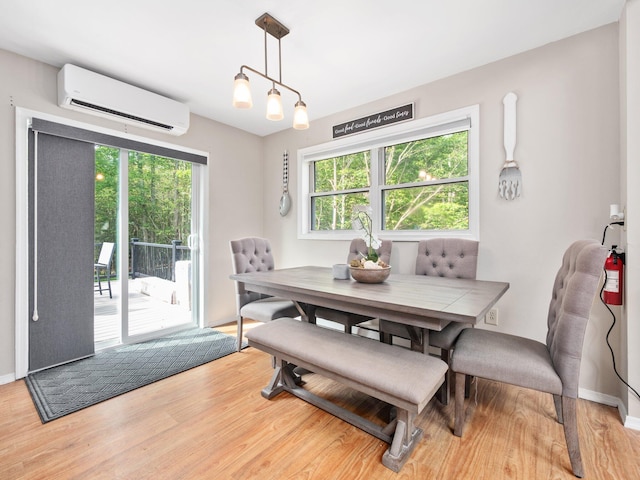 1533 Black Birch Way, Tobyhanna, PA 18466 - dining room featuring a wall mounted air conditioner, healthy amount of natural light, and wood finished floors
