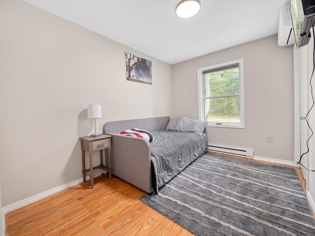 1533 Black Birch Way, Tobyhanna, PA 18466 - bedroom featuring a baseboard heating unit, light wood finished floors, and a wall unit AC