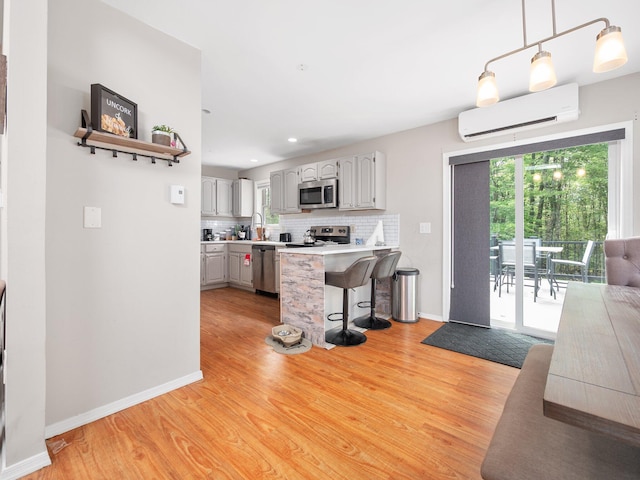 1533 Black Birch Way, Tobyhanna, PA 18466 - kitchen with stainless steel appliances, an AC wall unit, healthy amount of natural light, light wood-style floors, and recessed lighting