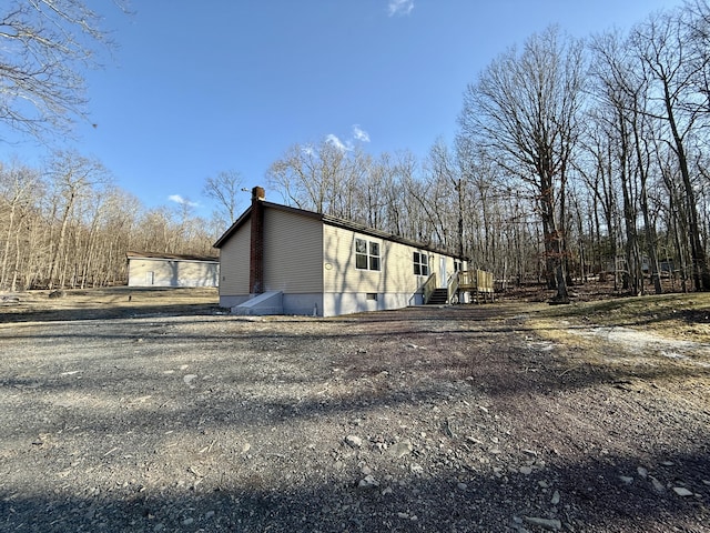 view of property exterior featuring a chimney