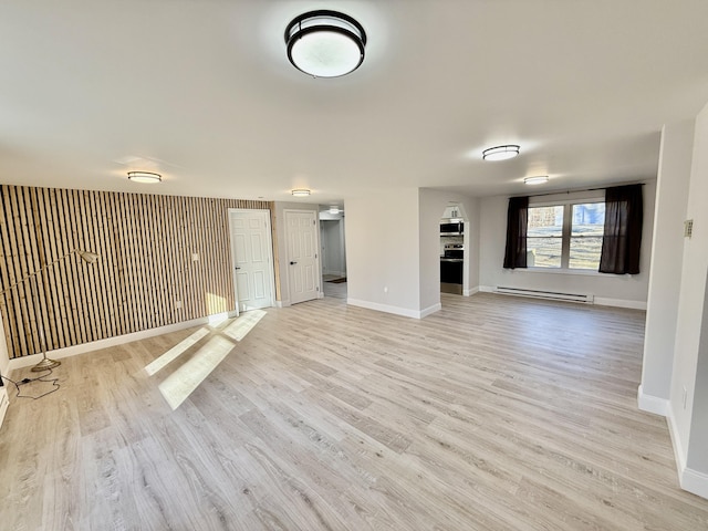 unfurnished living room with light wood finished floors, baseboards, and baseboard heating