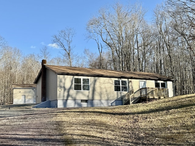 view of front of house featuring a wooden deck and a chimney