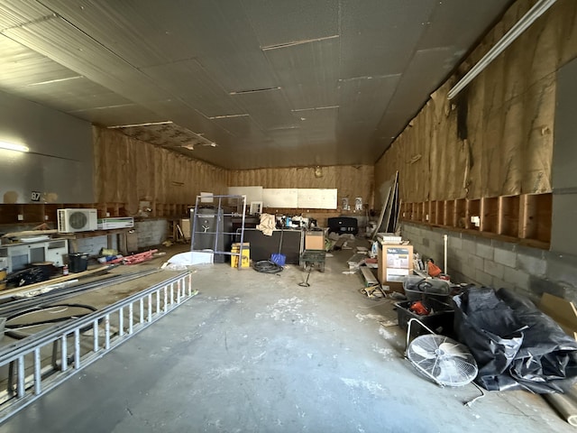 interior space with concrete block wall and concrete floors