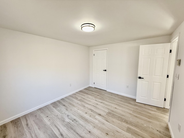 unfurnished bedroom featuring light wood-style floors and baseboards