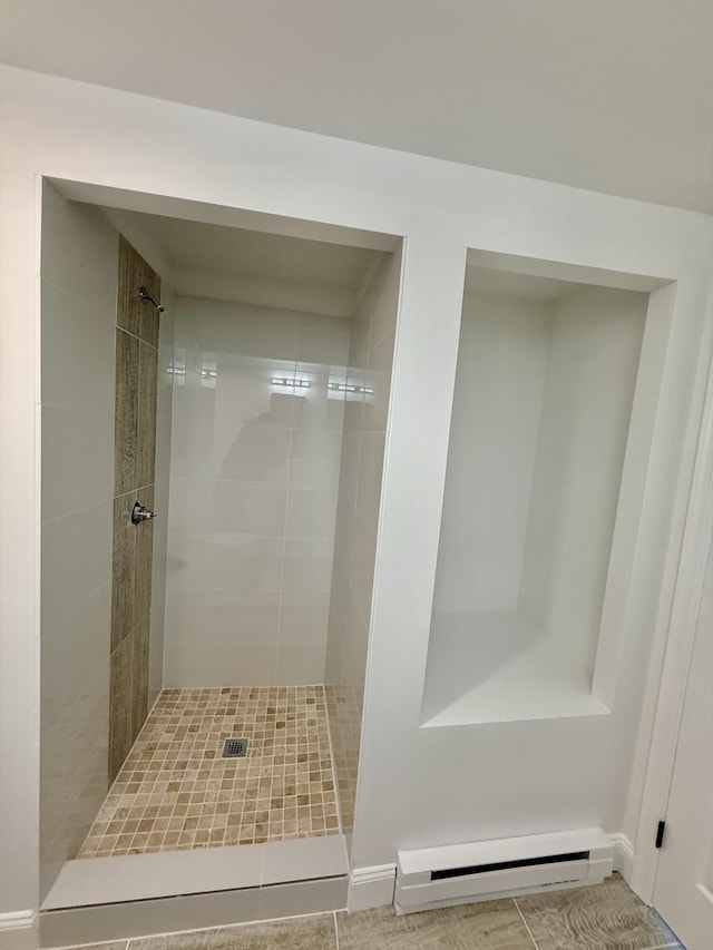 full bath with a stall shower and a baseboard heating unit