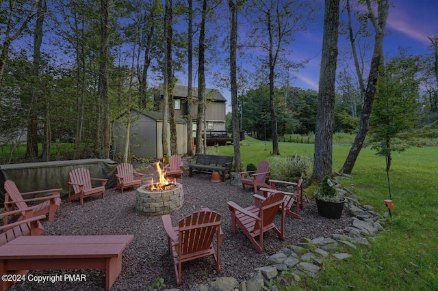 view of yard with an outdoor fire pit, an outdoor structure, and a shed