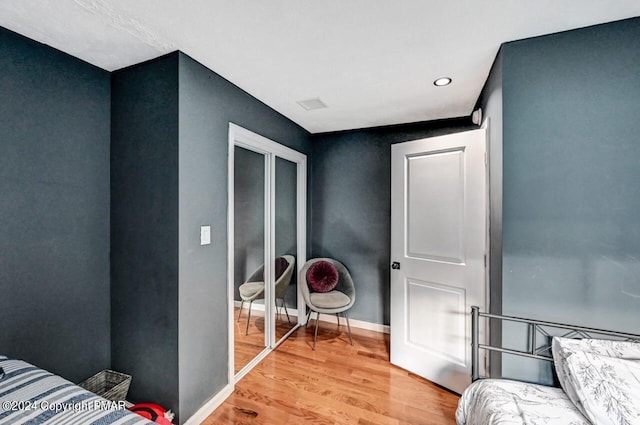 bedroom with baseboards and light wood finished floors