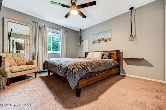 carpeted bedroom featuring a ceiling fan and baseboards